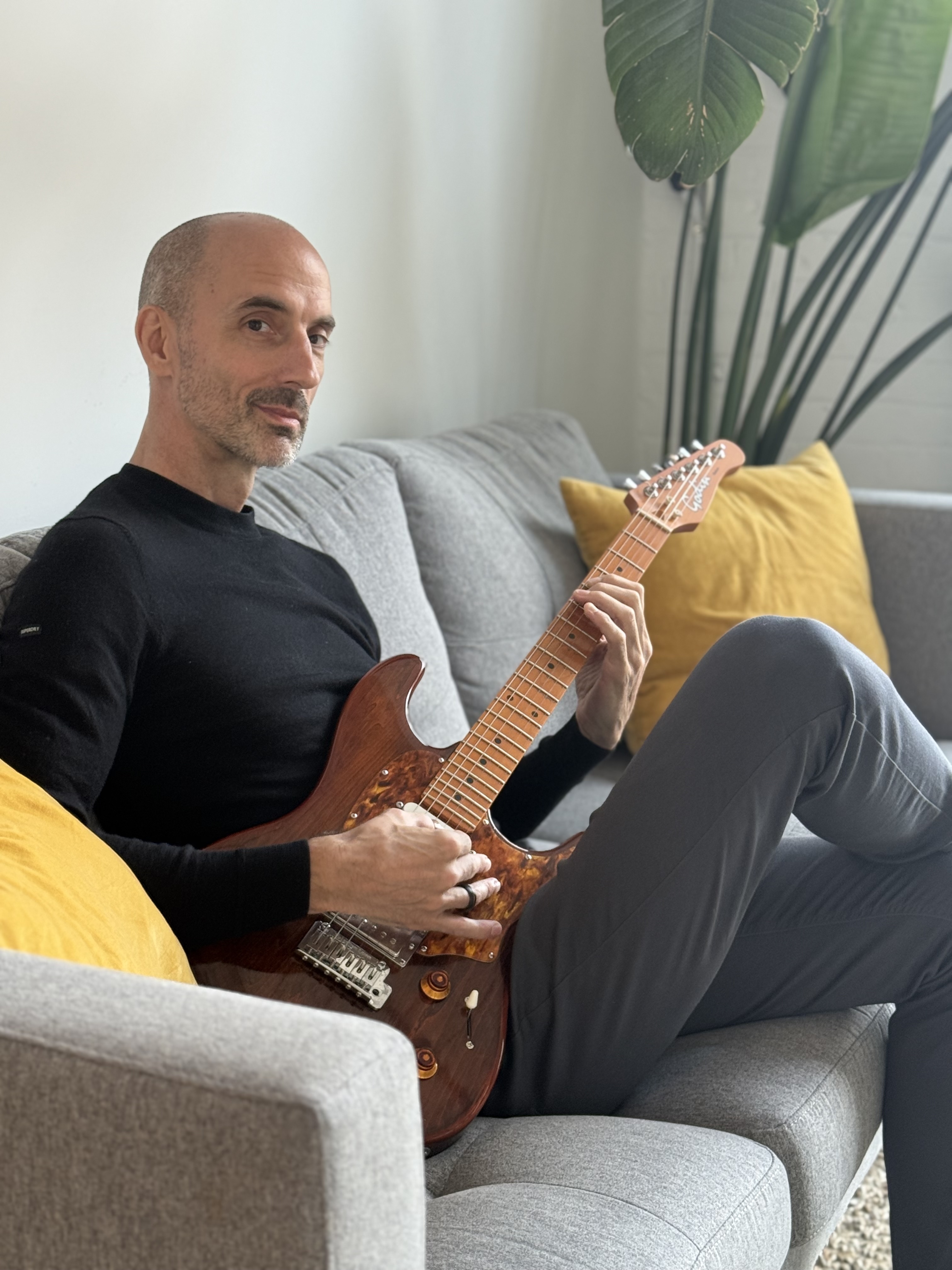 Mike James, music teacher in Toronto, with electric guitar